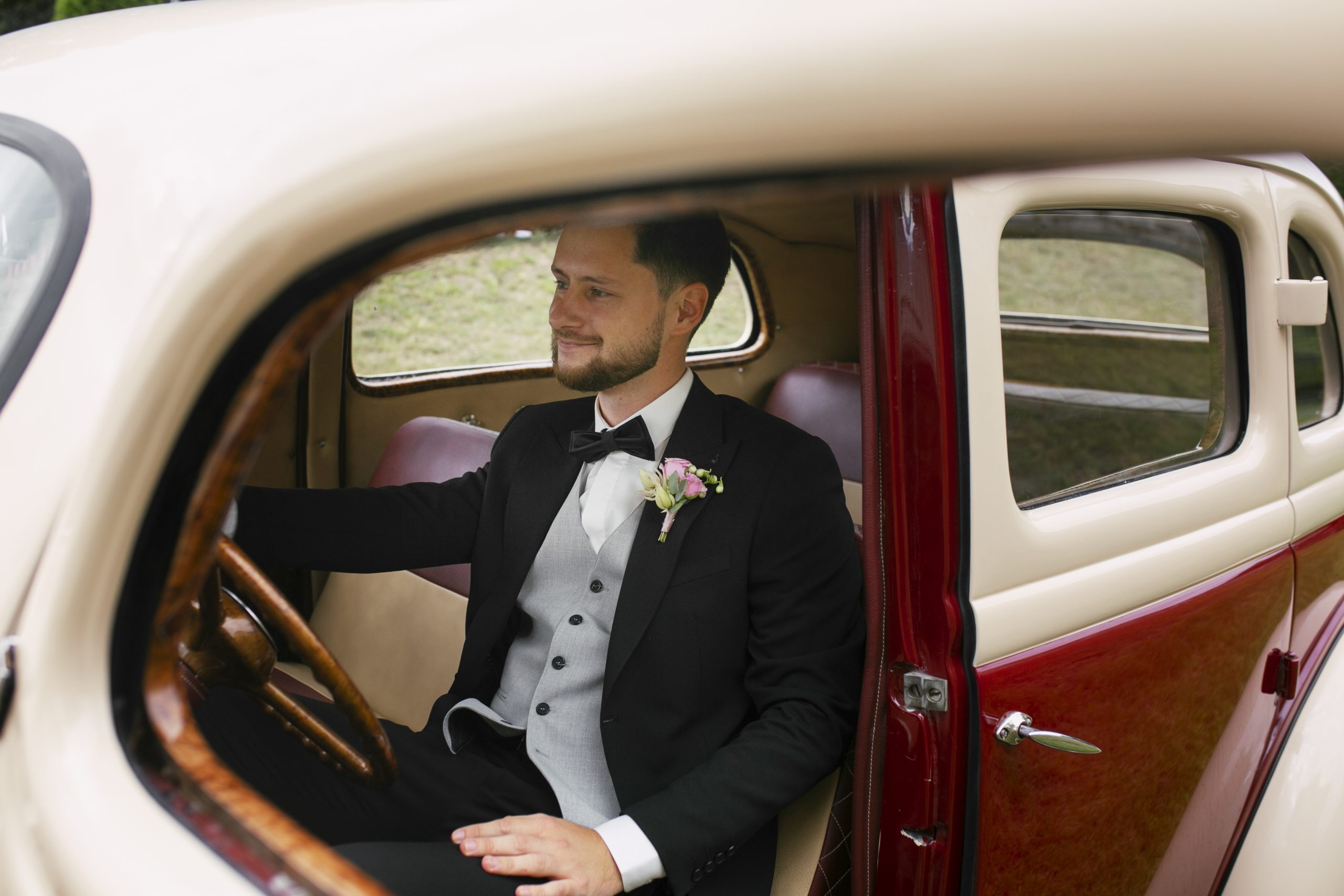 medium-shot-groom-posing-with-vintage-car